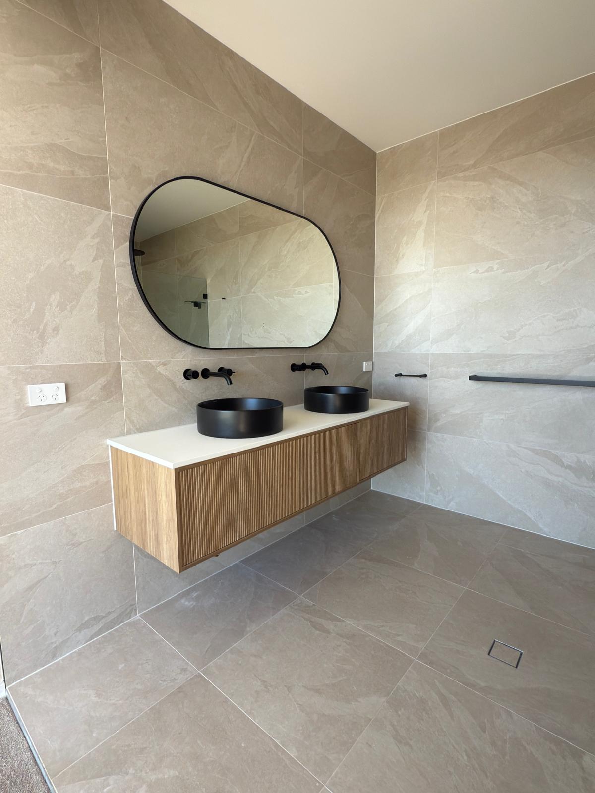 Master ensuite — pebble mirror & matte black — Shell Cove | Shellharbour Plumbing