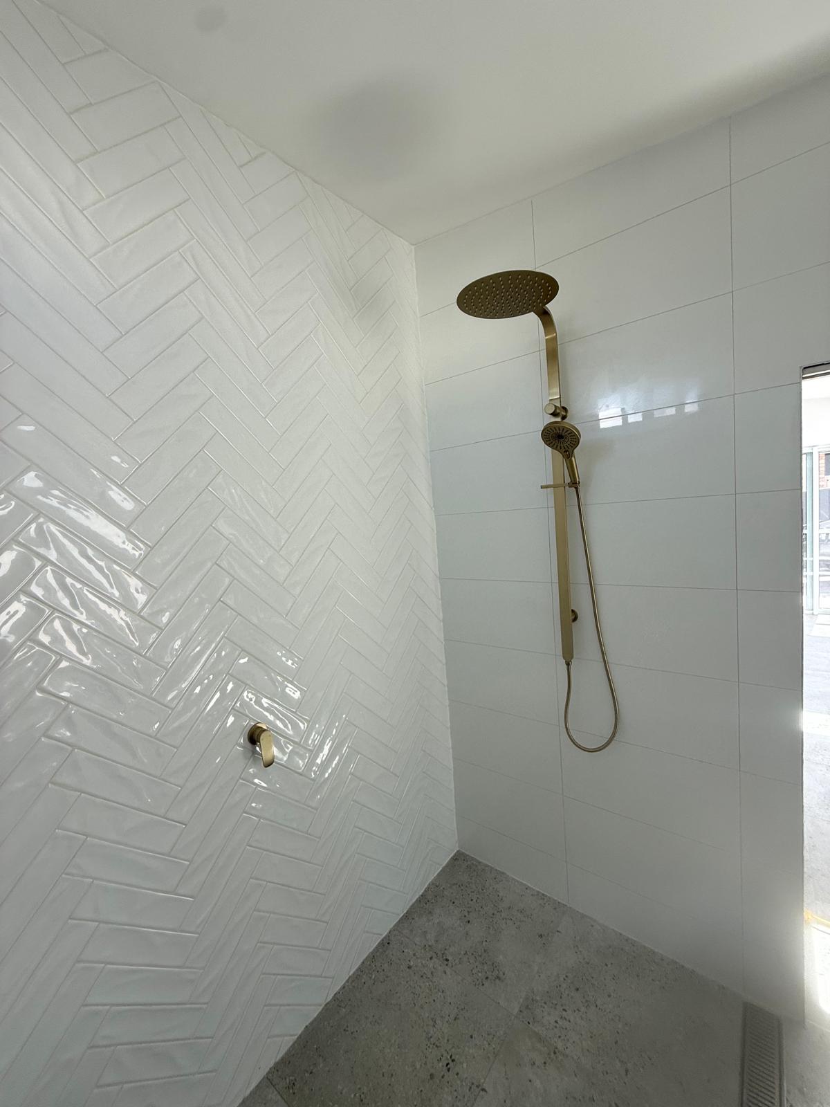 Walk-in shower — herringbone tile & brass — Kiama | Shellharbour Plumbing