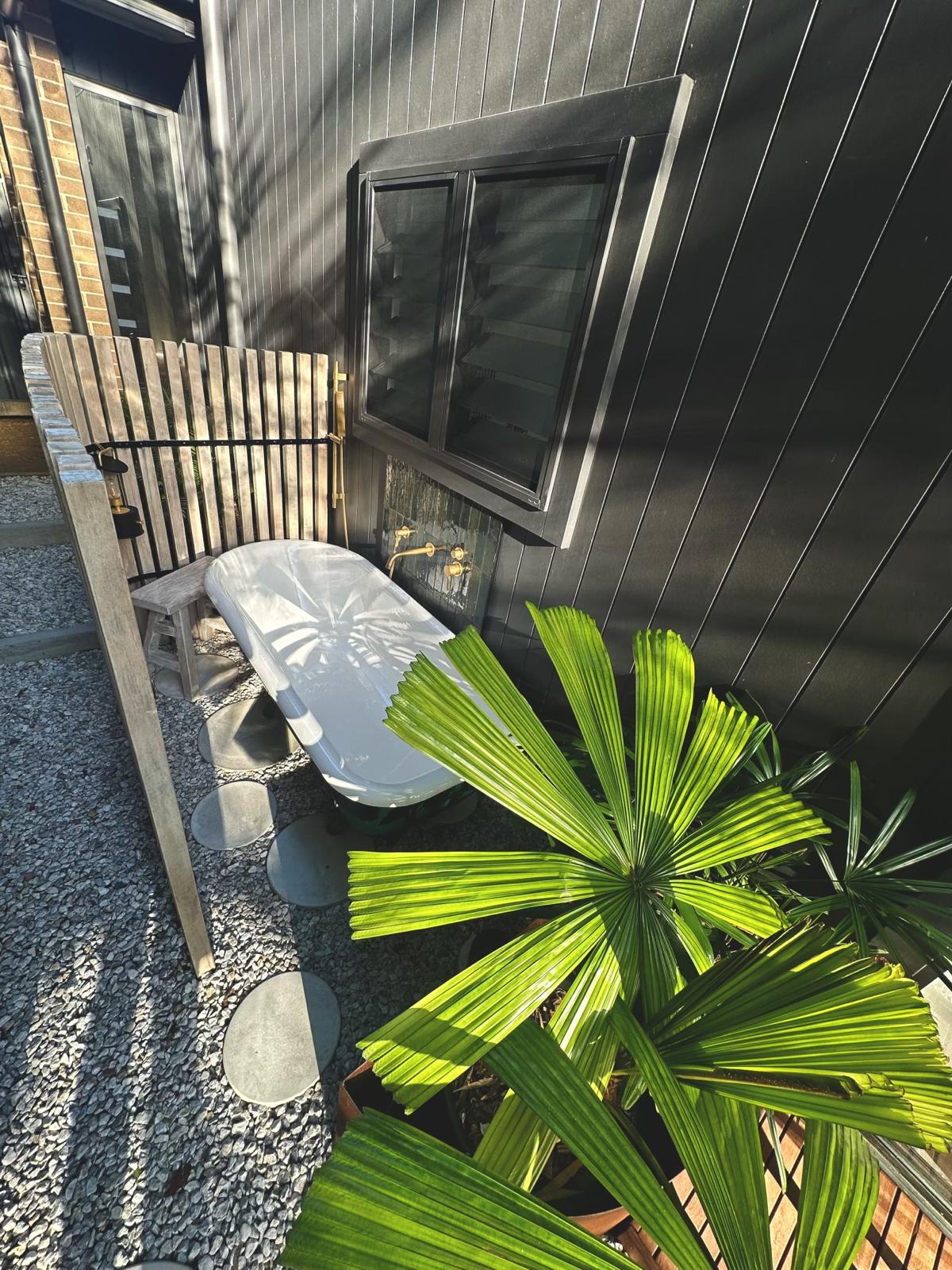 Outdoor bath — black cladding & brass — Gerringong | Shellharbour Plumbing